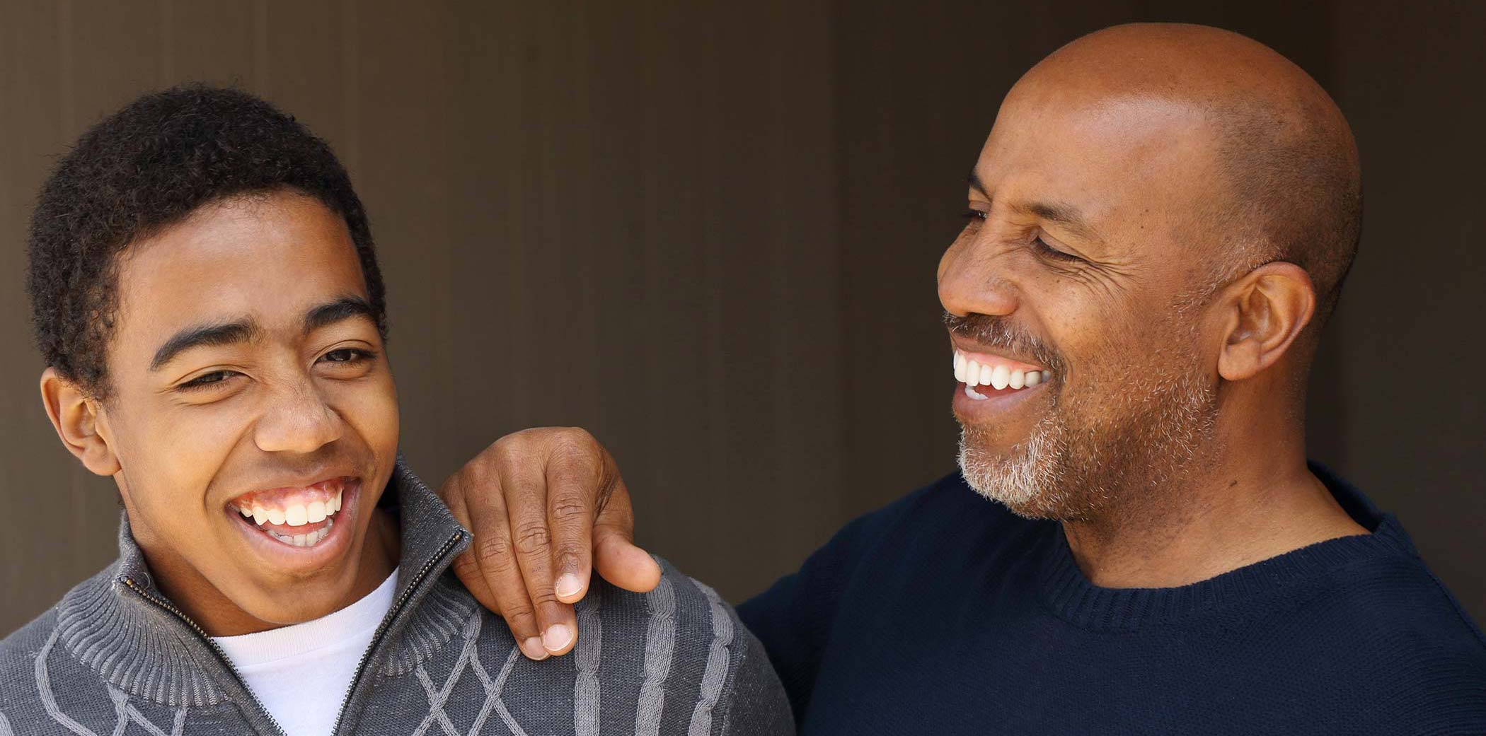 father and son smiling